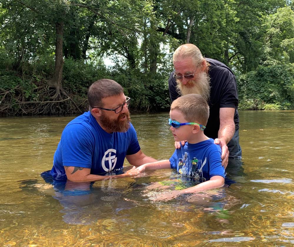 child being baptized in st james mo with grace and truth fellowship church